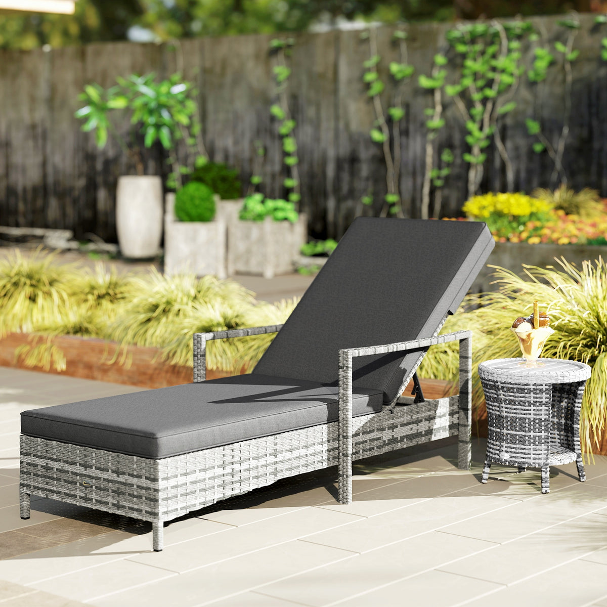 Mixed gray wicker sun lounger with dark cushion and raised backrest