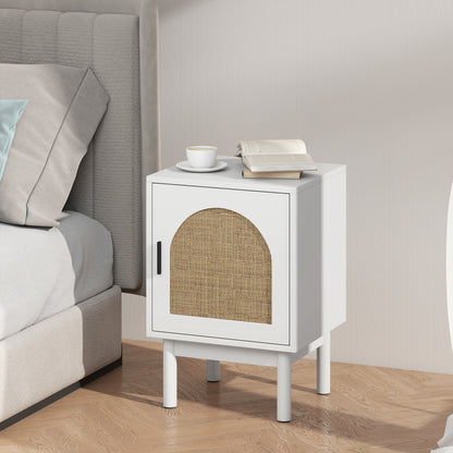 White bedside table with arched rattan door beside a bed