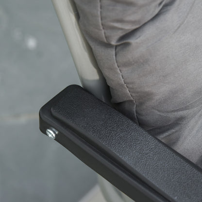 Close-up of a black textured armrest beside the gray padded lounger seat