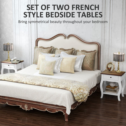 White French-style bedside table beside a bed, with brown top, drawer and open shelf