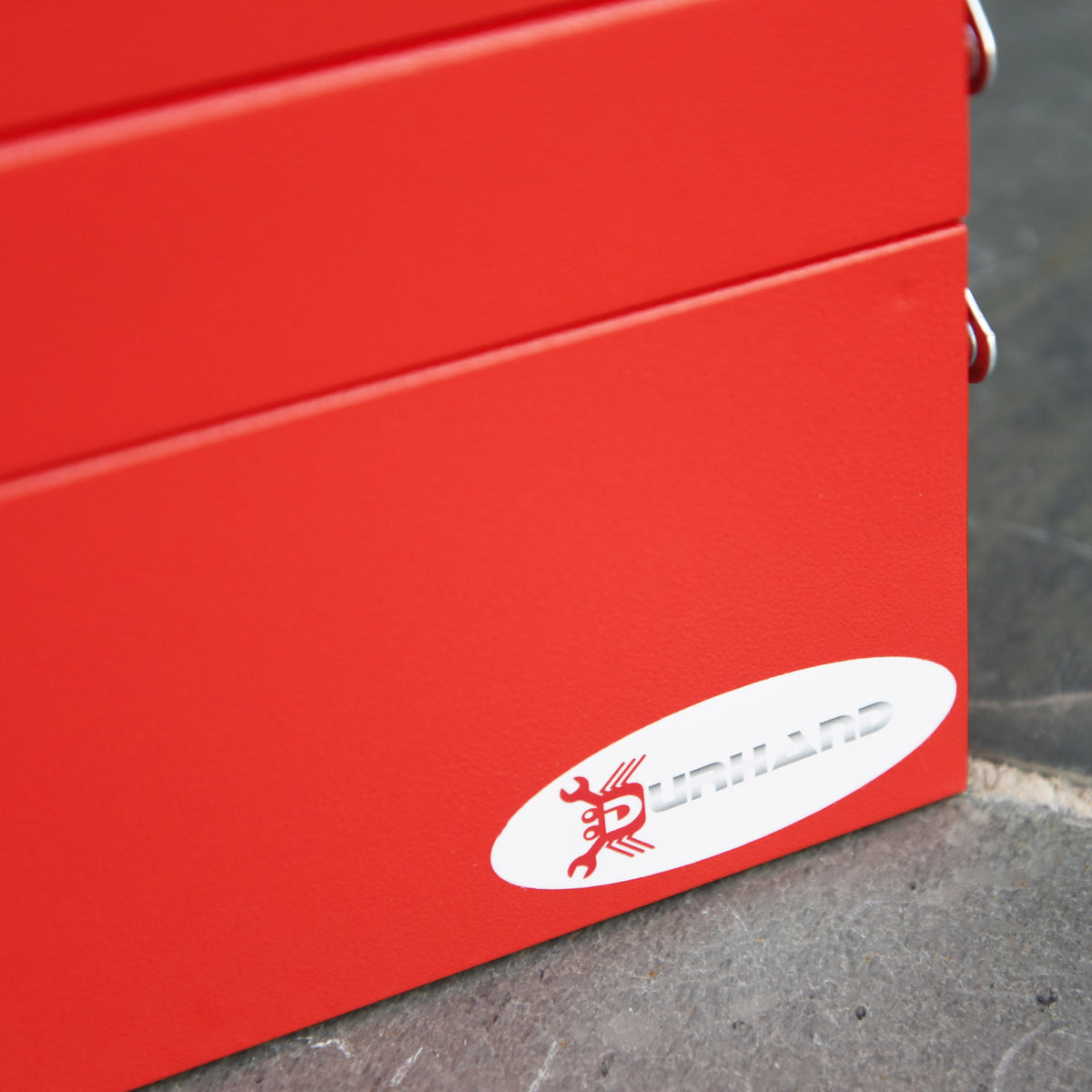 Close-up of the red toolbox metal body and DURHAND logo