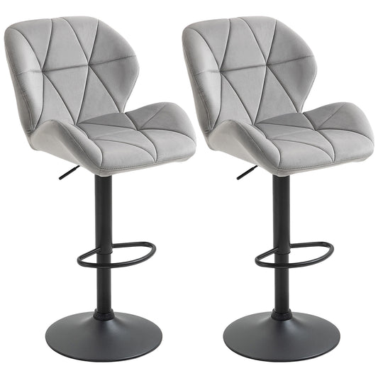Pair of light gray velvet-touch bar stools with tufted seats, black footrests and round bases