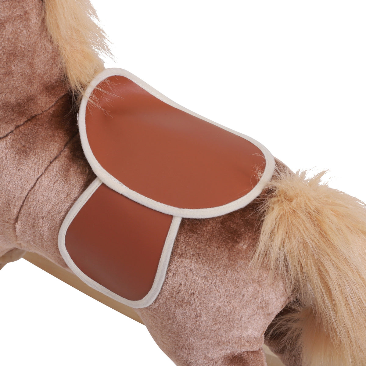 Close-up of brown rocking horse saddle with white trim and plush tail