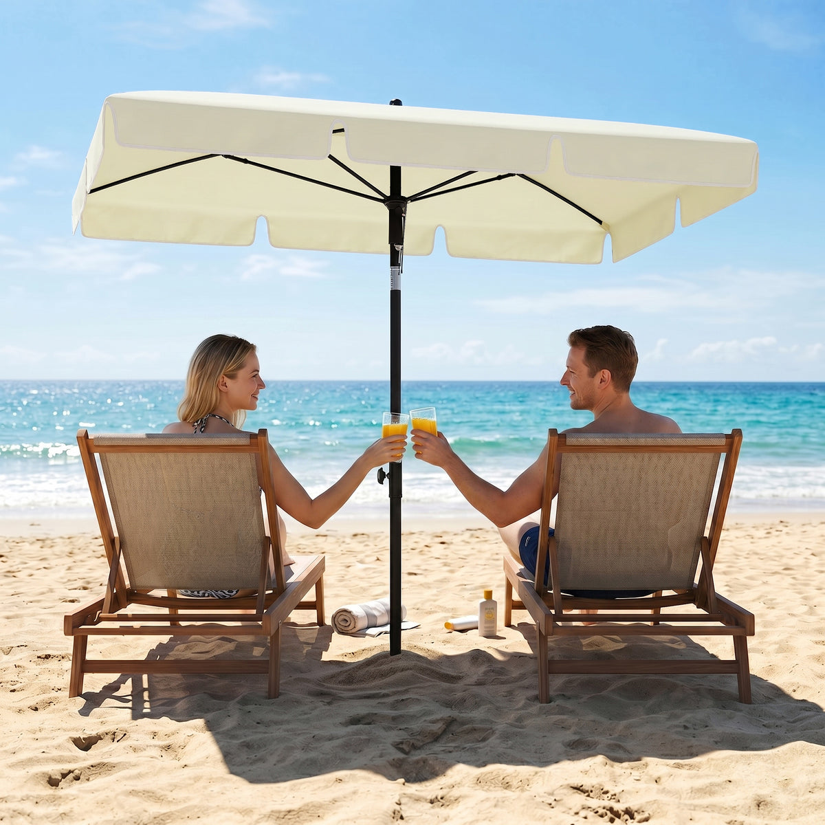 Cream rectangular parasol with ruffled canopy shading two beach chairs