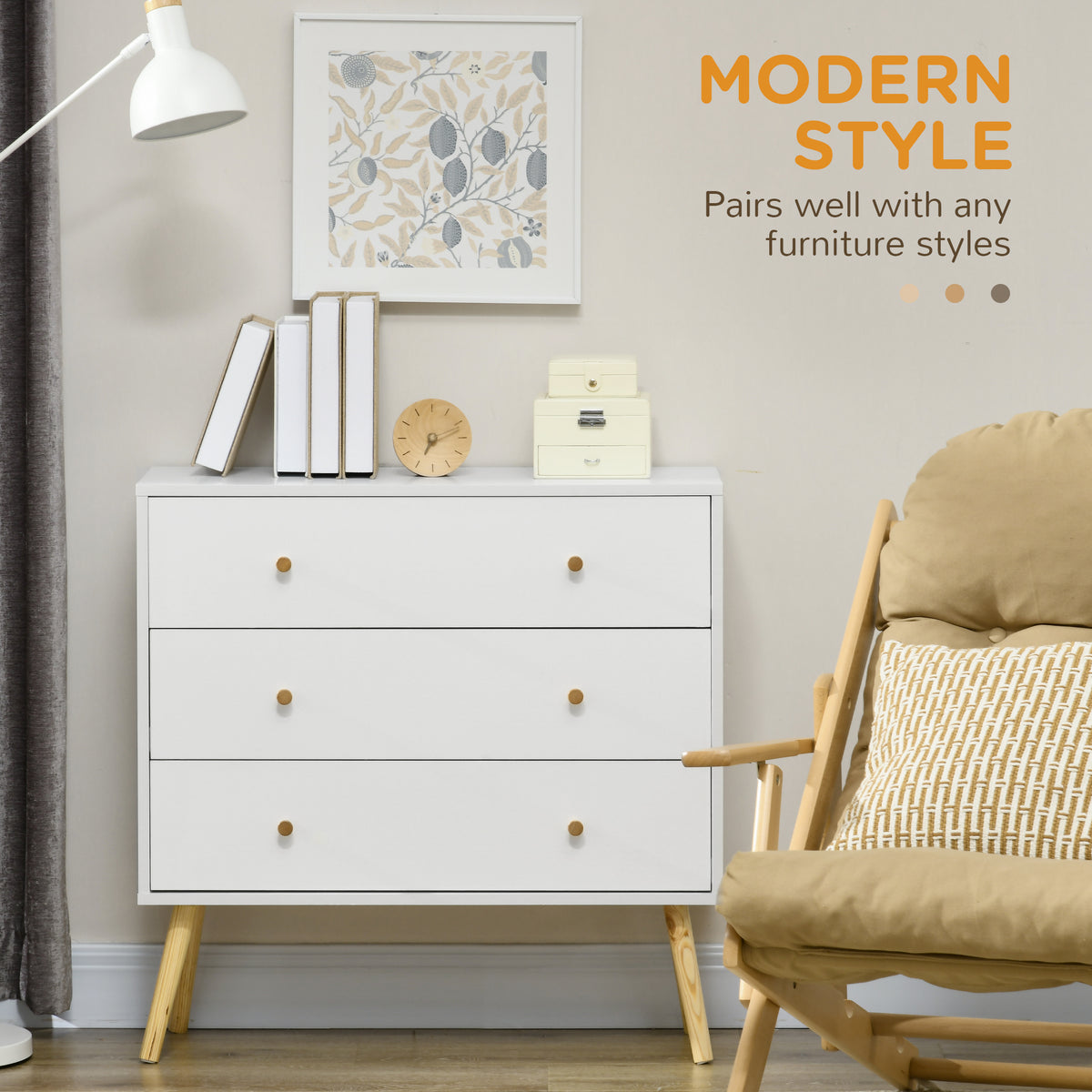 White three-drawer chest with wood legs and knobs, styled in a living room