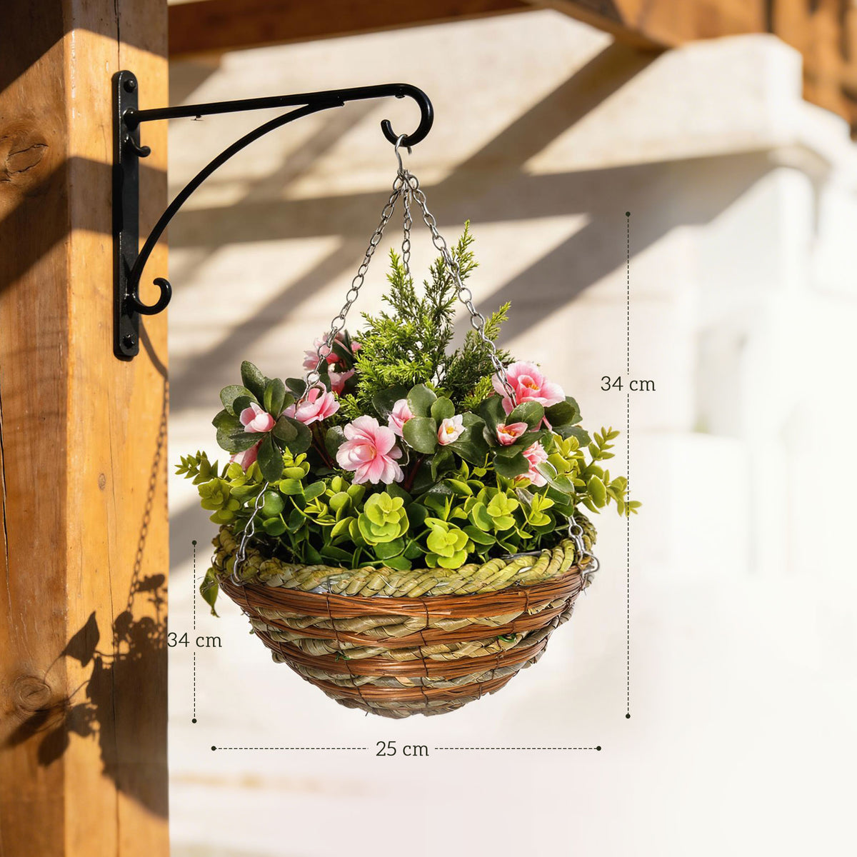 Hanging flower basket with pink blooms, green foliage, woven pot and metal chain