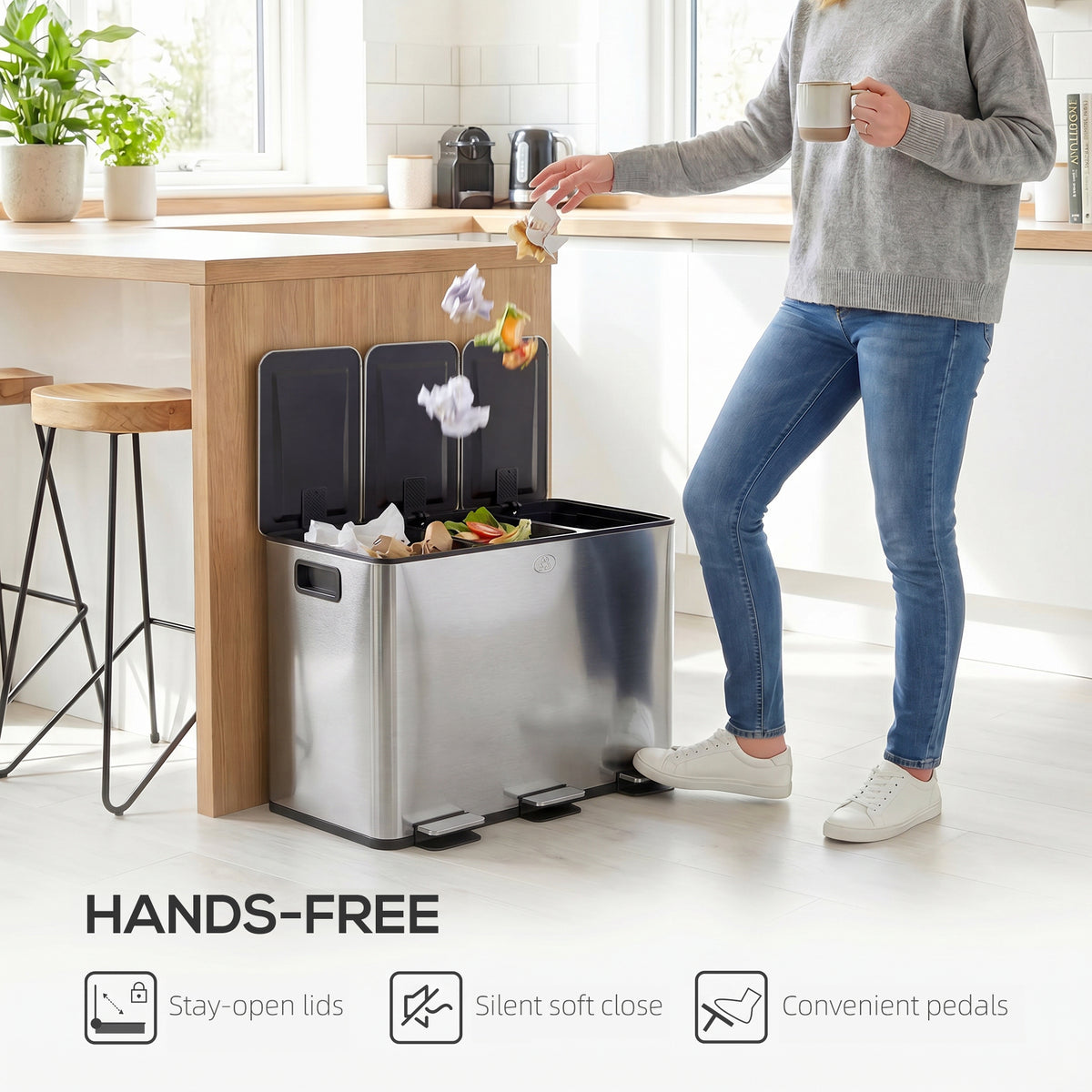 Silver-tone triple pedal bin with open lids and a foot pedal in use