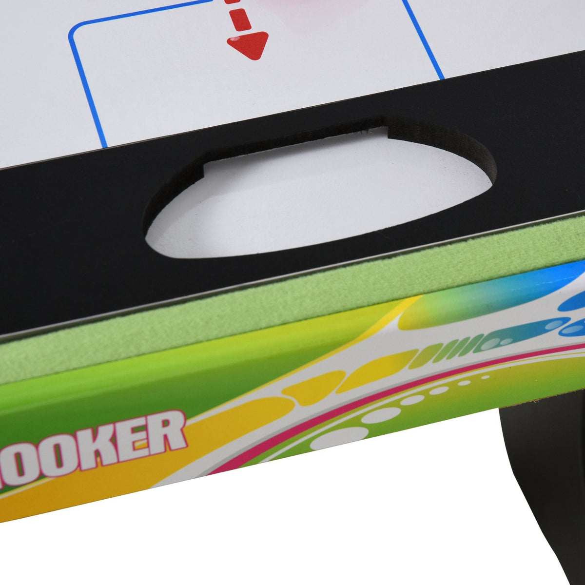 Close-up of the gaming table's black puck or ball holder beside its green playing surface