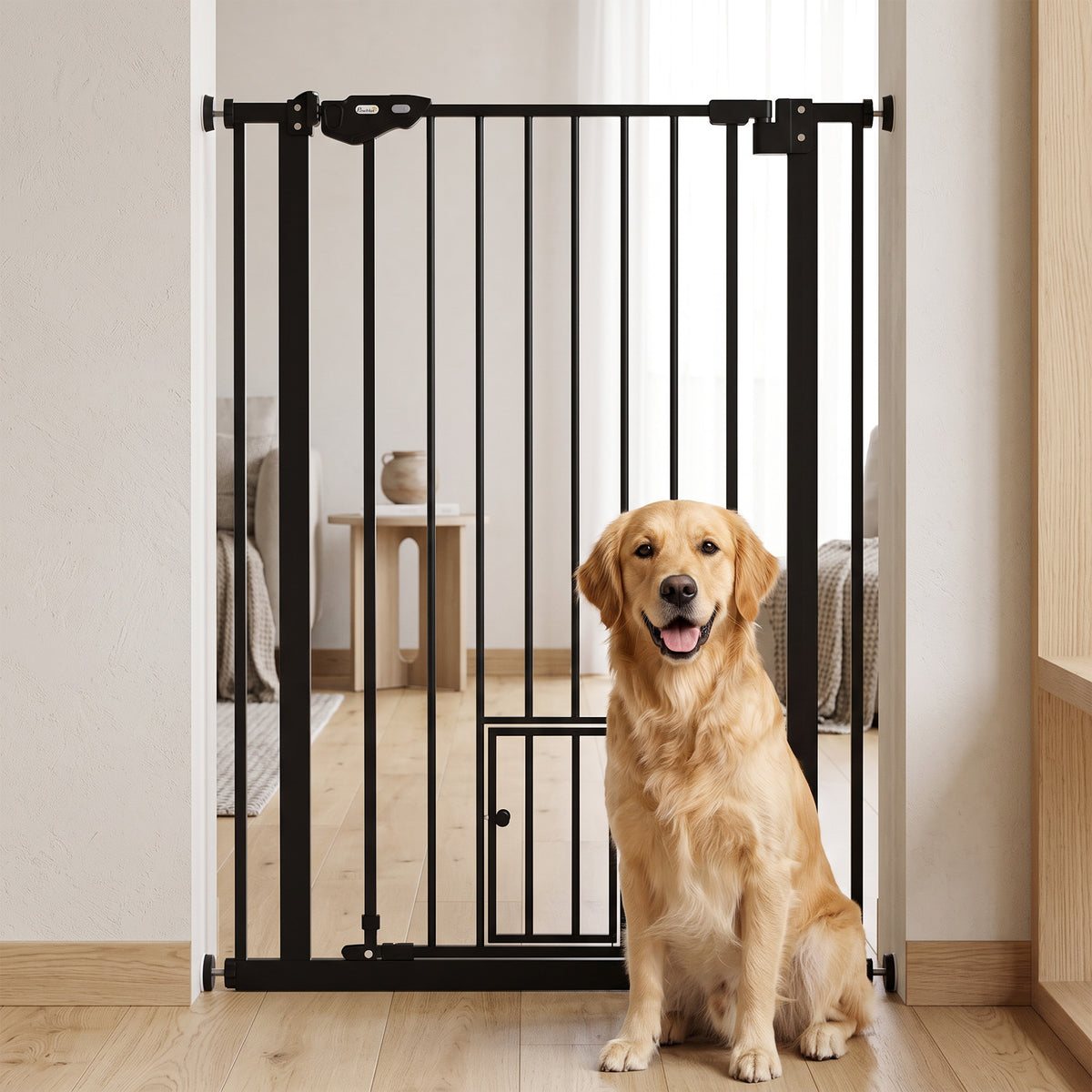 Black metal pet gate with small cat flap installed in a doorway