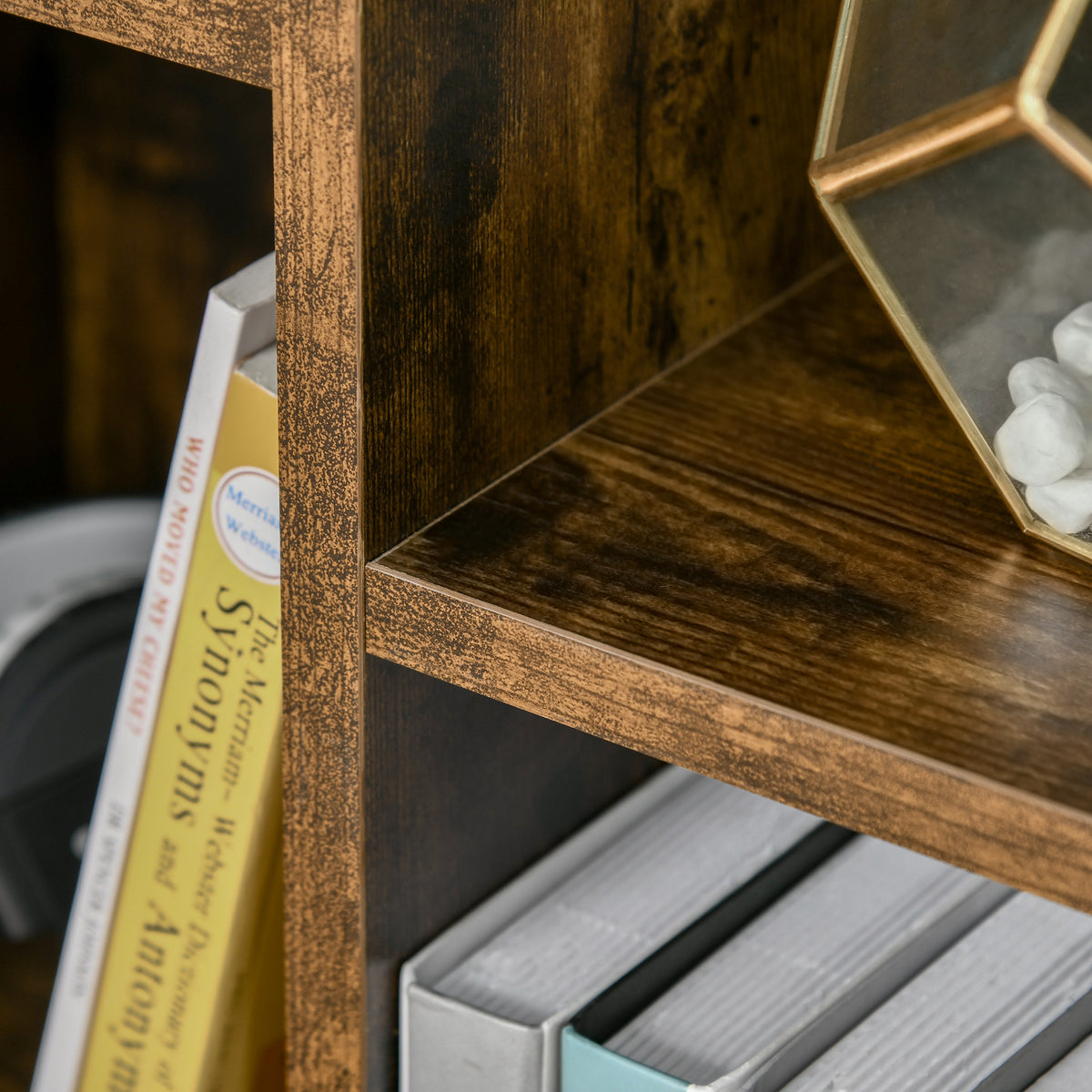 Close-up of rustic brown wood-effect bookcase shelves and textured frame.