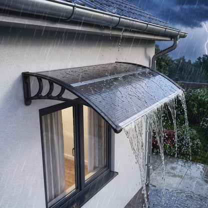Outsunny black polycarbonate door canopy mounted above a window, shedding rain