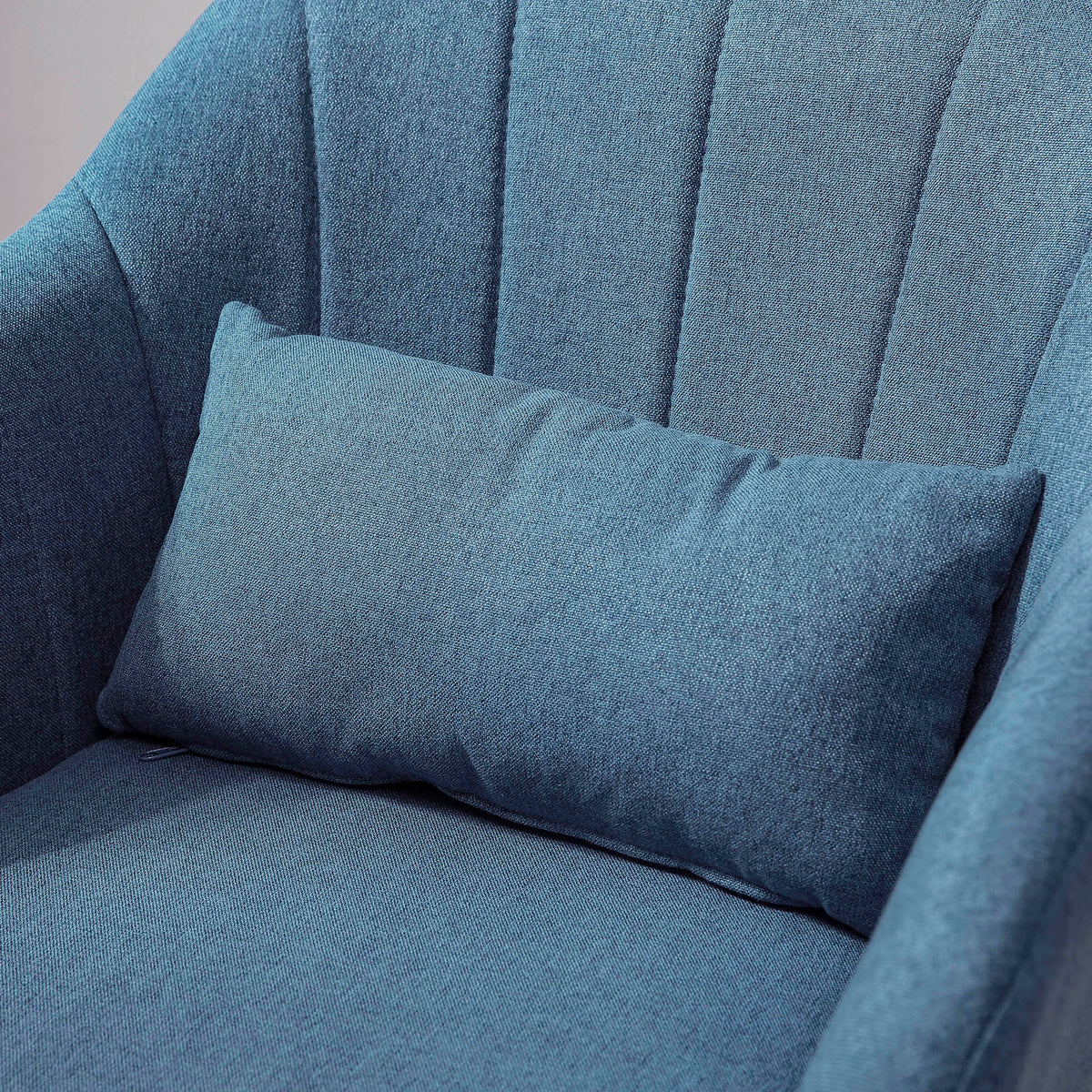 Close-up of blue chair's lumbar pillow and channel-stitched backrest