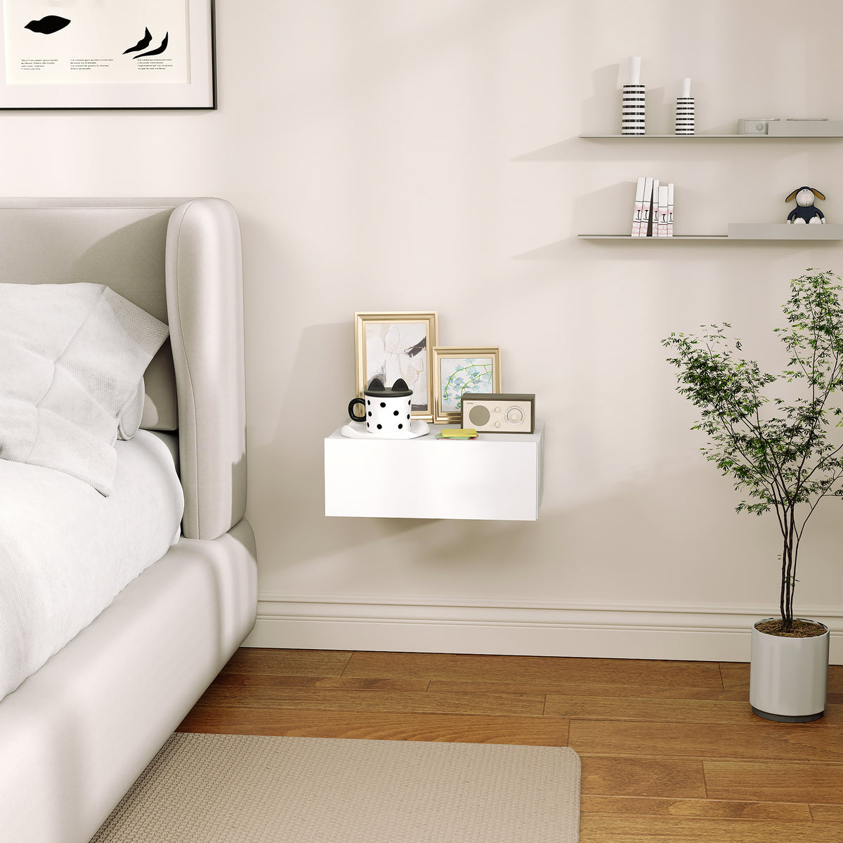 White floating bedside table shown mounted beside a bed.