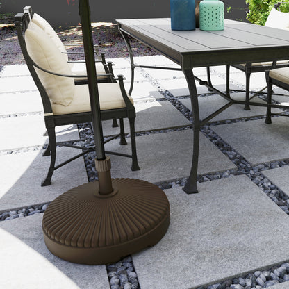 Outsunny brown umbrella base holding a patio umbrella beside outdoor dining furniture