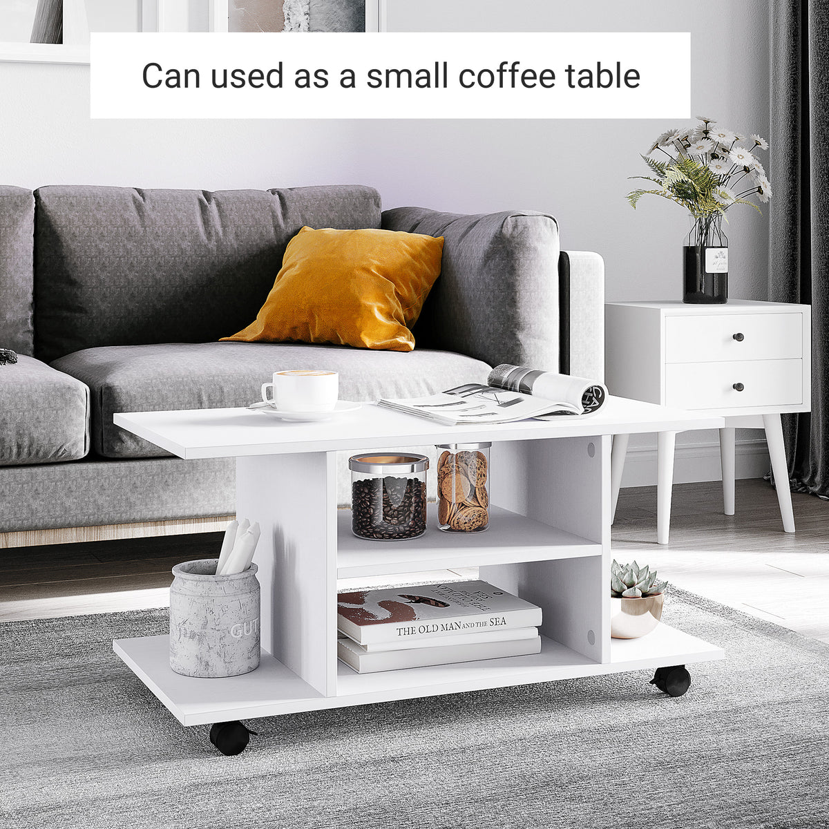 White wheeled TV stand used as a coffee table, with open storage shelves