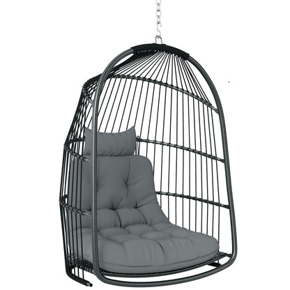 Dark gray hanging egg chair with a woven frame, chain, tufted seat cushion and headrest