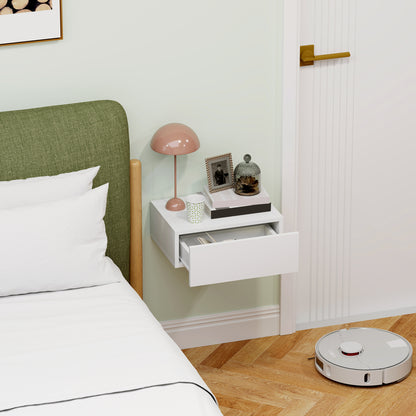 White wall-mounted nightstand with a wide drawer pulled open.