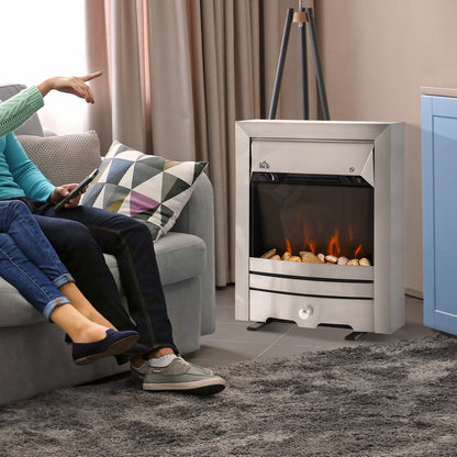 Stainless steel electric fireplace heater with flame effect, shown beside a sofa