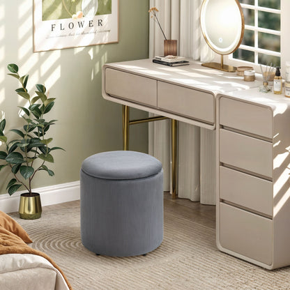 Grey corduroy storage ottoman with a round padded lid