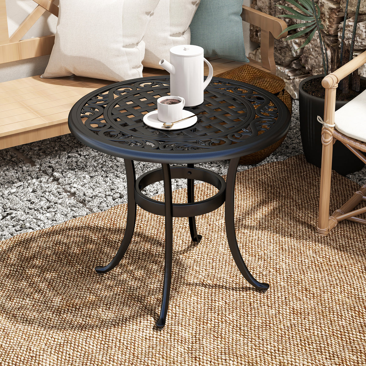 Black cast aluminum table with ornate lattice top and circular lower support ring