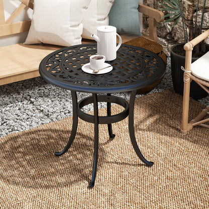 Black cast aluminum table with ornate lattice top and circular lower support ring