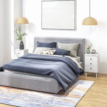 Pair of white three-drawer bedside tables flanking a bed