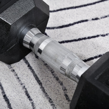 Close-up of a hex dumbbell's textured silver handle and black rubber heads.