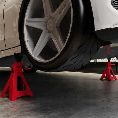 Red jack stands supporting a vehicle near its wheel
