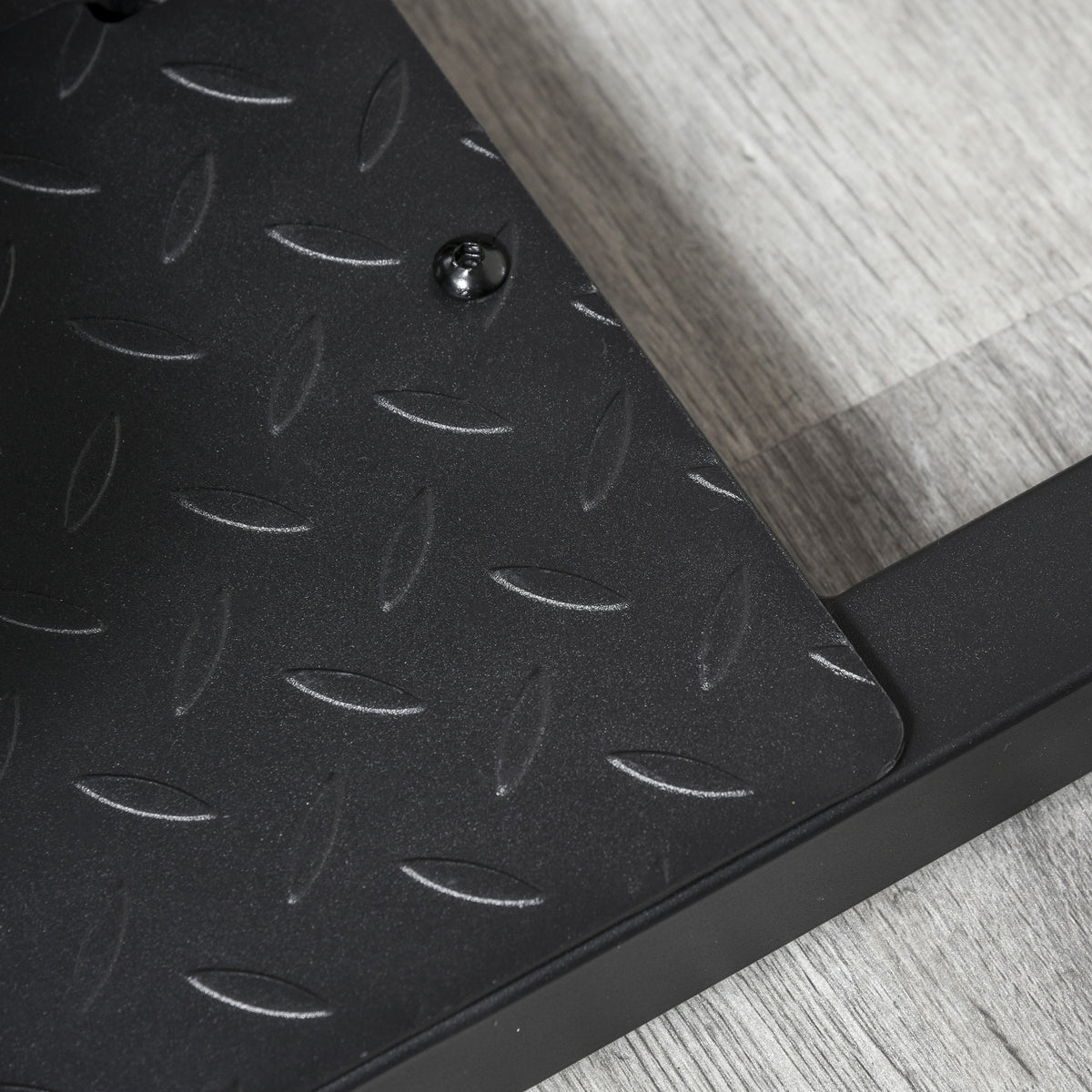 Close-up of the HOMCOM squat machine's textured black steel foot platform