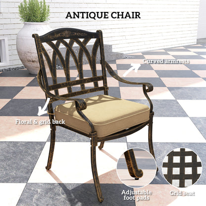 Antique-style cast aluminium chair with beige cushion, curved arms and floral grid back