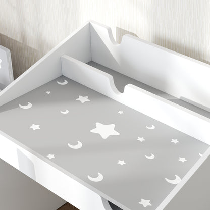 Close-up of gray desktop with white moon and star pattern and raised side panels