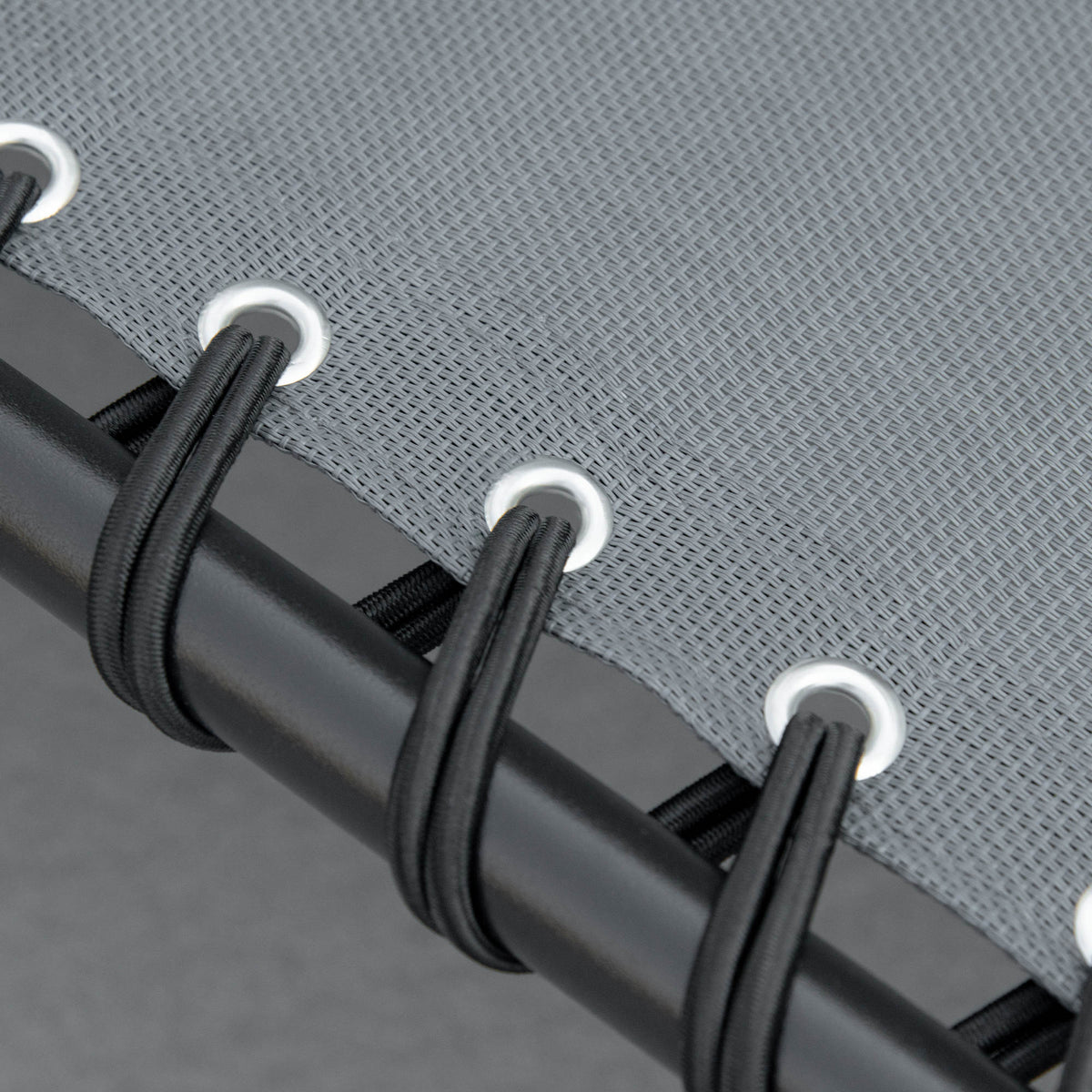 Close-up of the grey lounger mesh secured to its frame with elastic cords