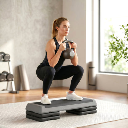 SPORTNOW fitness stepper supporting a woman doing a weighted squat
