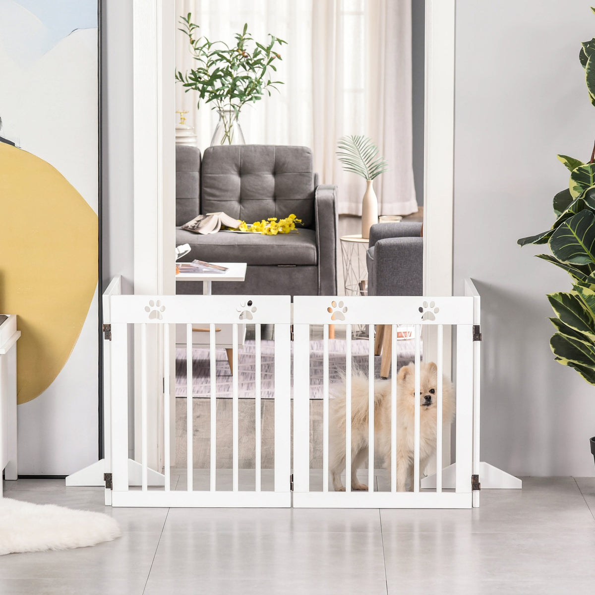 PawHut white pet gate arranged across a doorway to contain a small dog