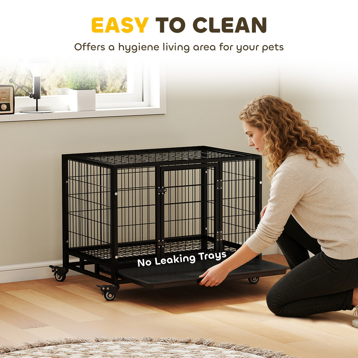 Black metal dog crate with a removable tray on caster wheels