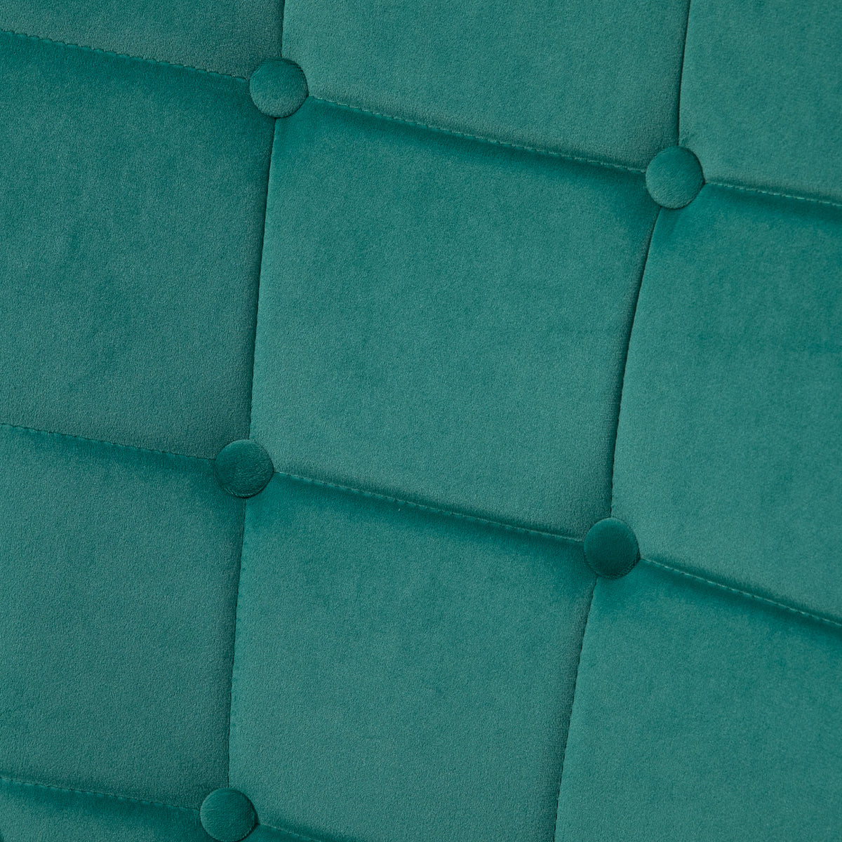 Dark green velvet armchair back with square button tufting and stitched panels