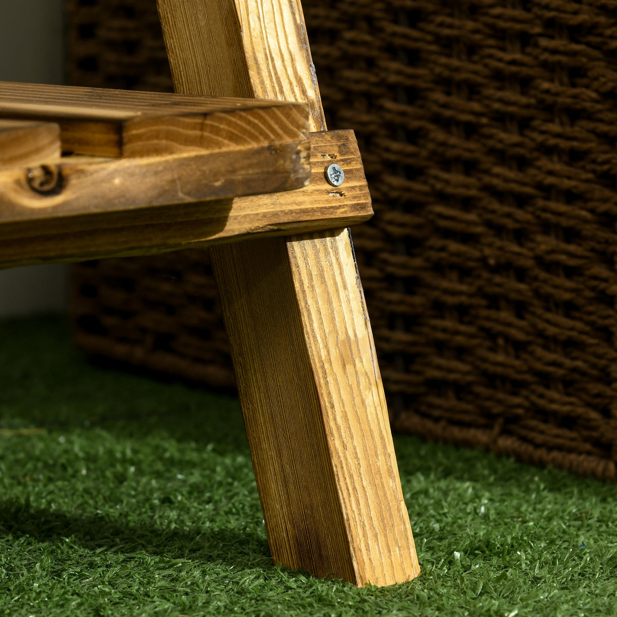 Close-up of the wooden plant stand's leg and shelf joint with metal fastener