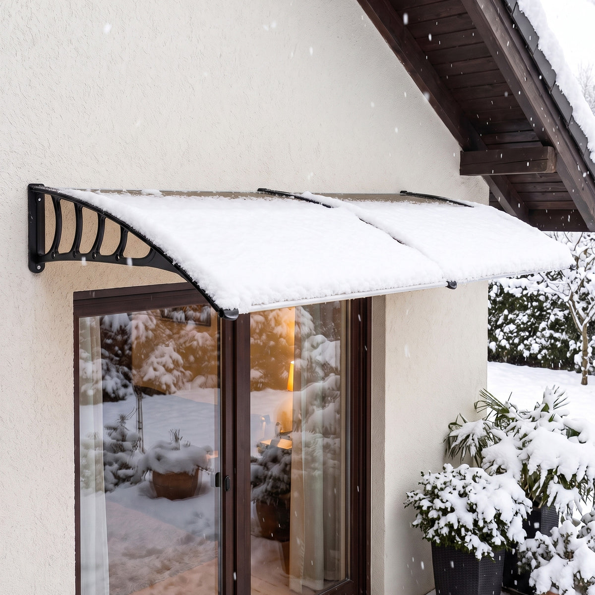 Outsunny brown door canopy mounted over an entrance with snow resting on its roof